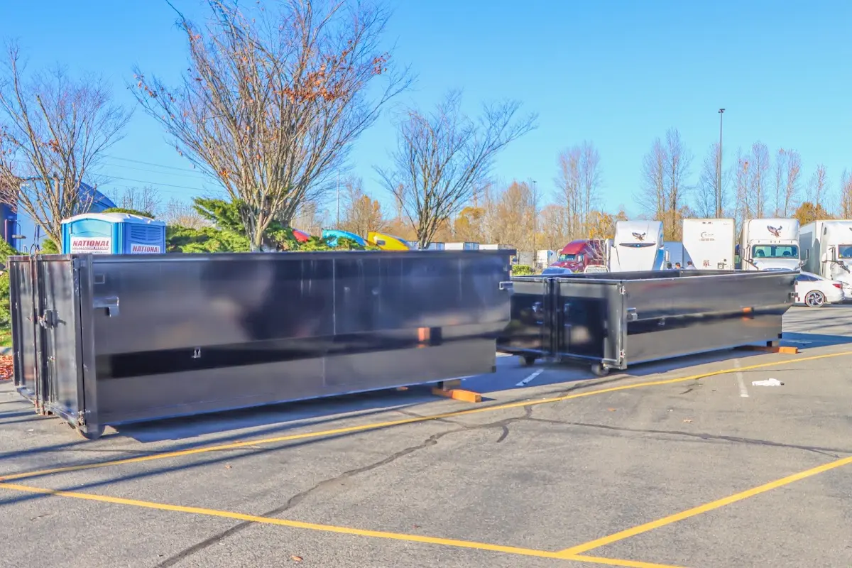 Professional dumpster rental service with roll-off container on residential driveway in Port St. John